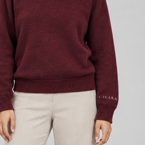 The ribbed hem and cuff, wordmark set once on the left.